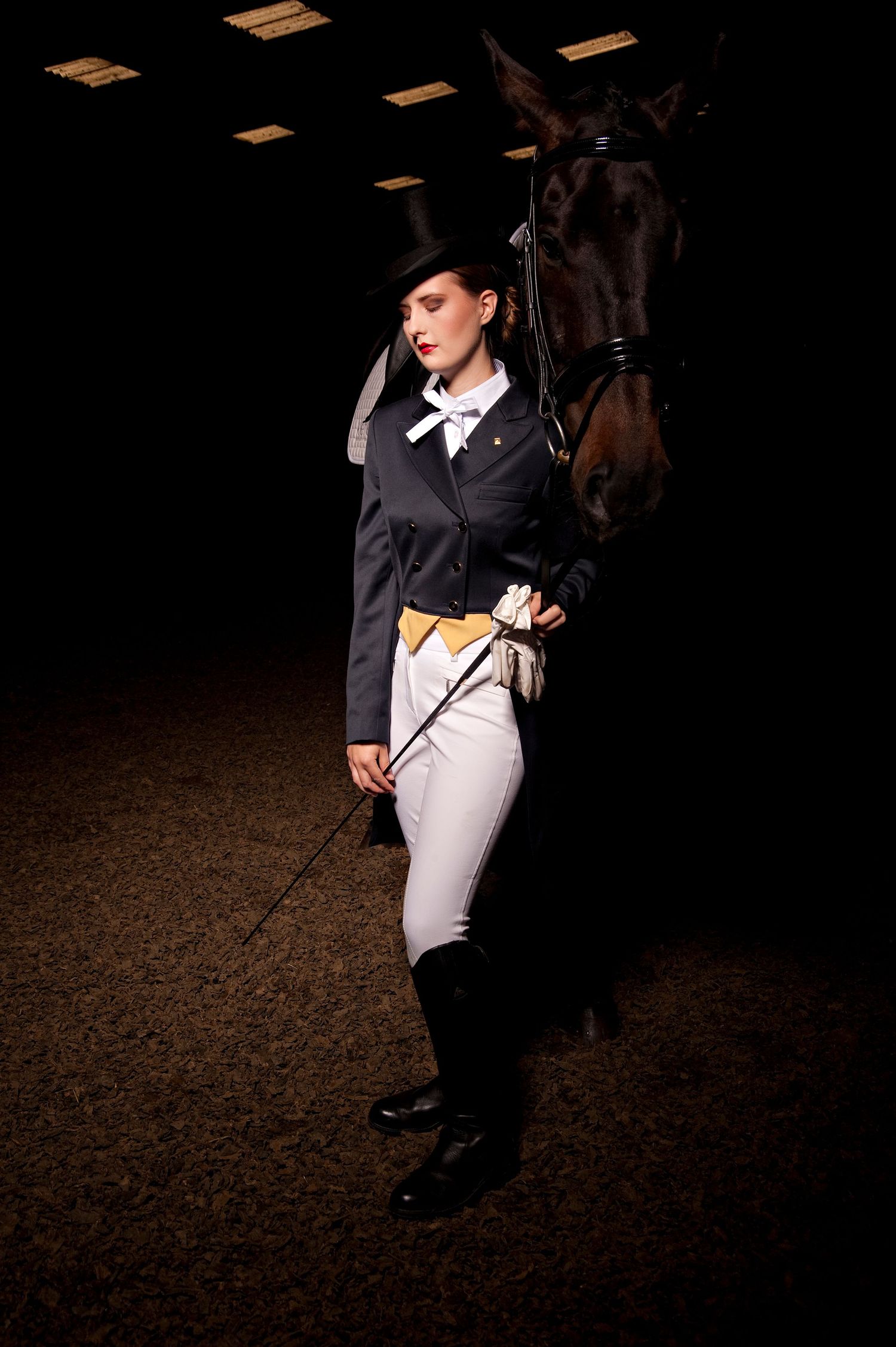 Editorial equestrian portrait of rider with horse in indoor arena, Water Farm, Suffolk