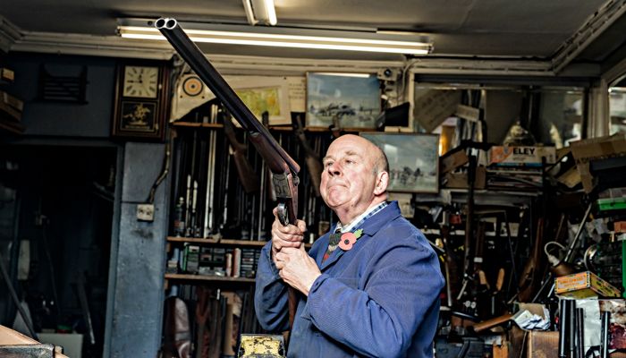 Environmental portrait of a traditional gunsmith working in his workshop, Halesworth, Suffolk