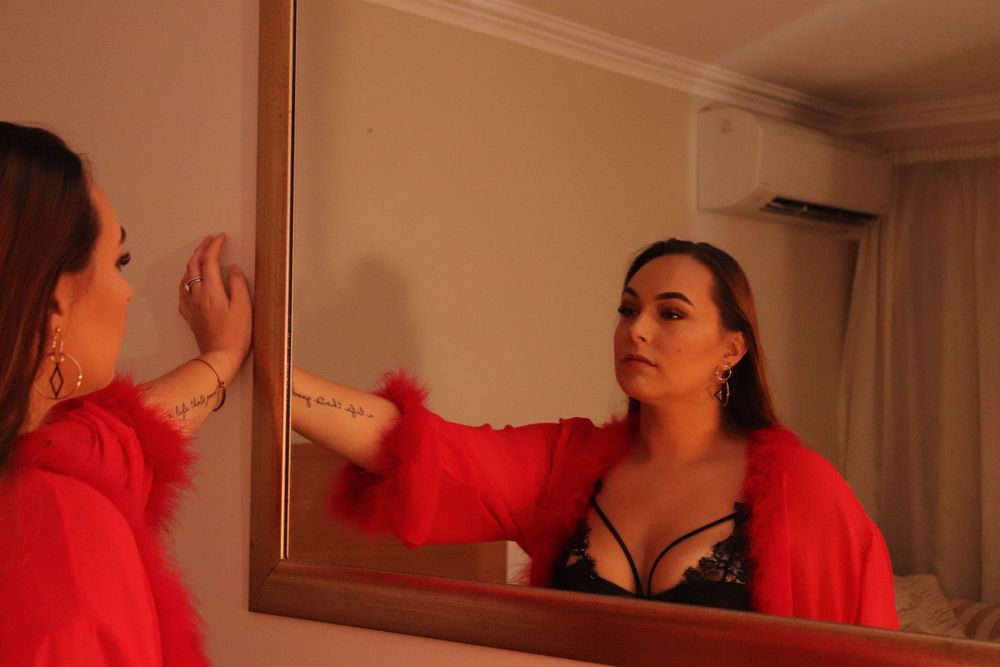 A woman posing for a boudoir photo