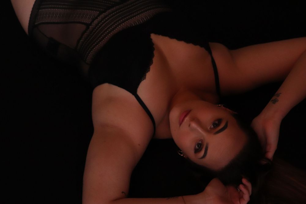 A woman posing for a boudoir photo