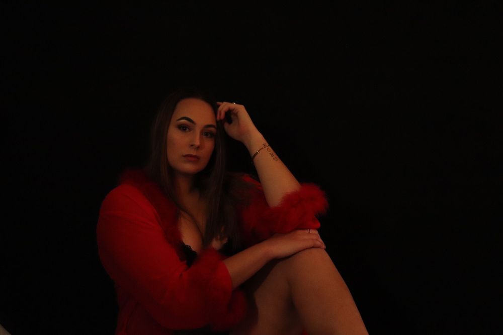 A woman posing for a boudoir photo