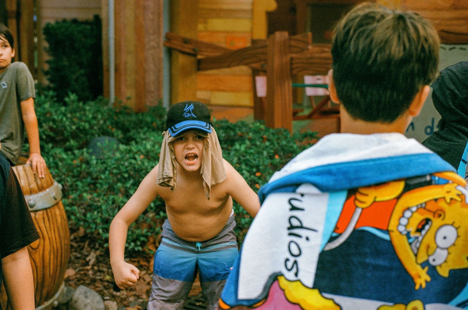 People interacting at a theme park with colorful clothing and backpacks.
