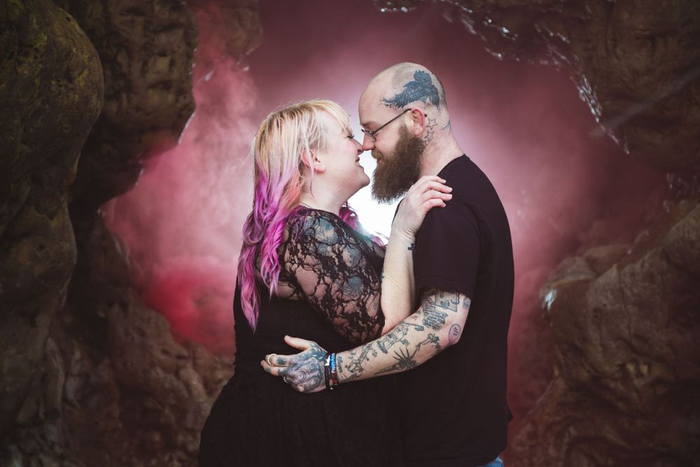 A romantic gothic style photo shoot with mystical pink fog and a full moon in the background.