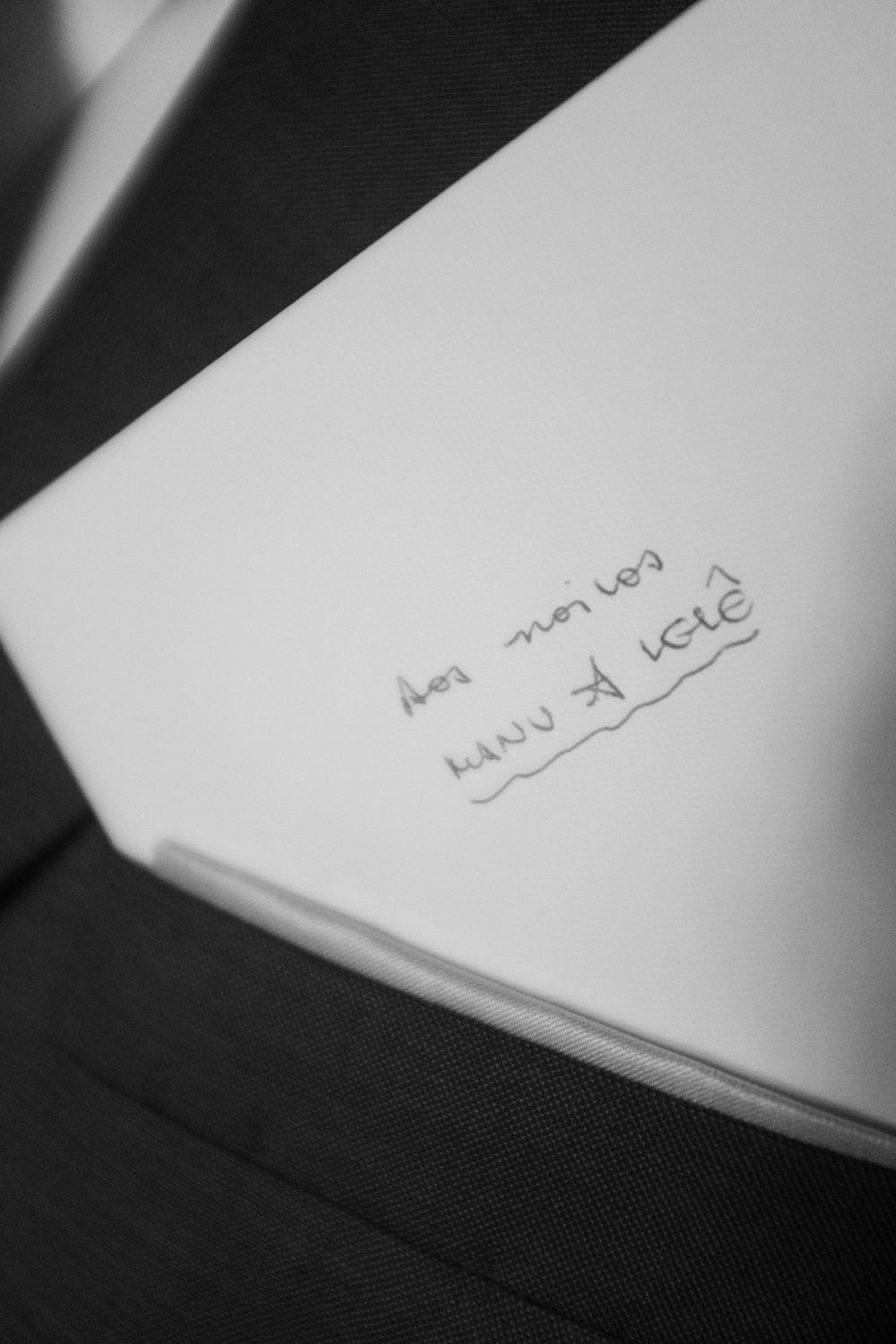Black and white close-up of handwritten text on white paper.
