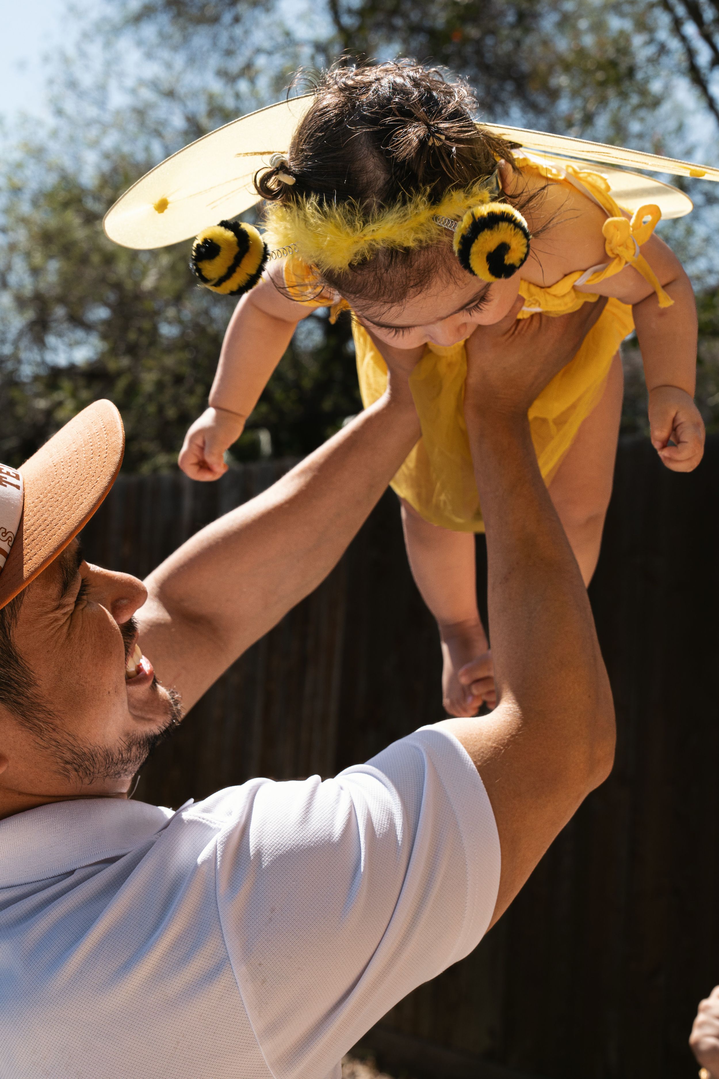 A sequence showing someone drinking from a yellow bottle outdoors on a sunny day.