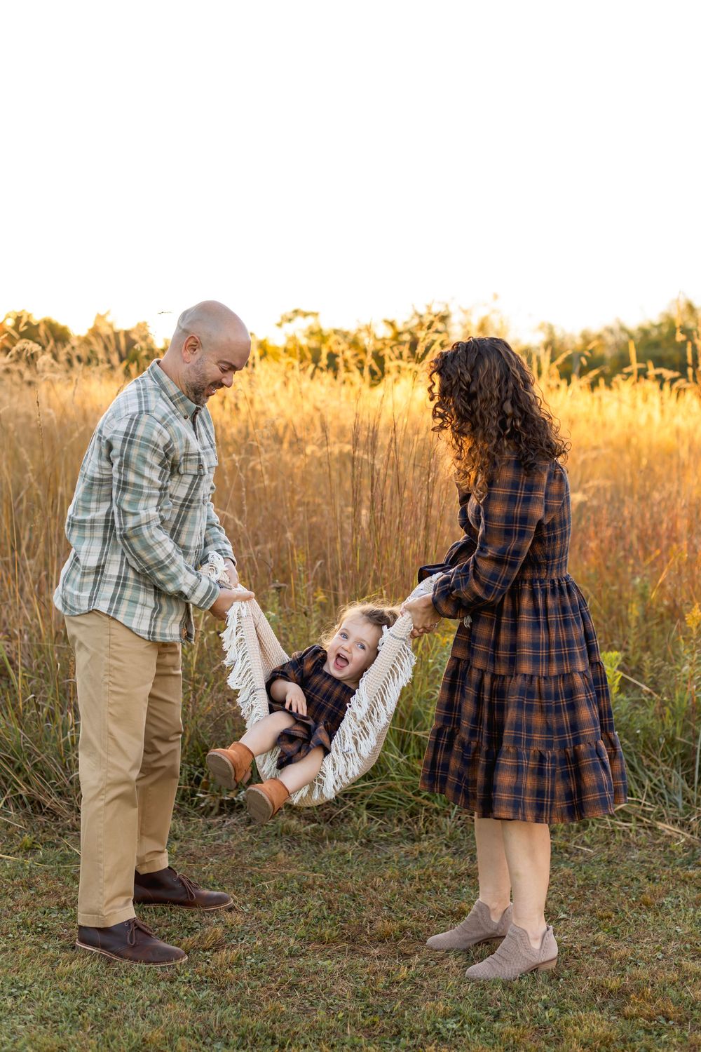 Playful family moment captured in golden field Nj Family Photographer in Sussex County