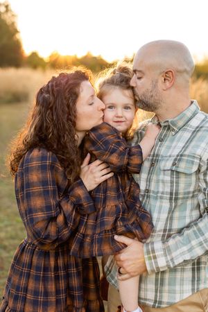 Family sharing tender moment together in golden sunset light Nj Family Photographer in Sussex County