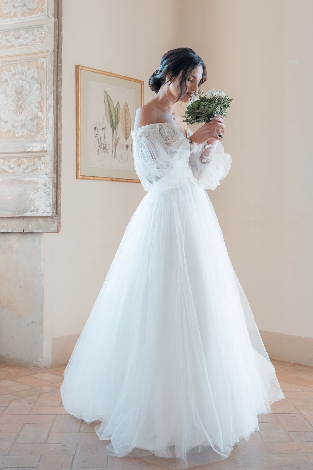 Bride in a flowing white ballgown twirls and poses in an elegant indoor setting.