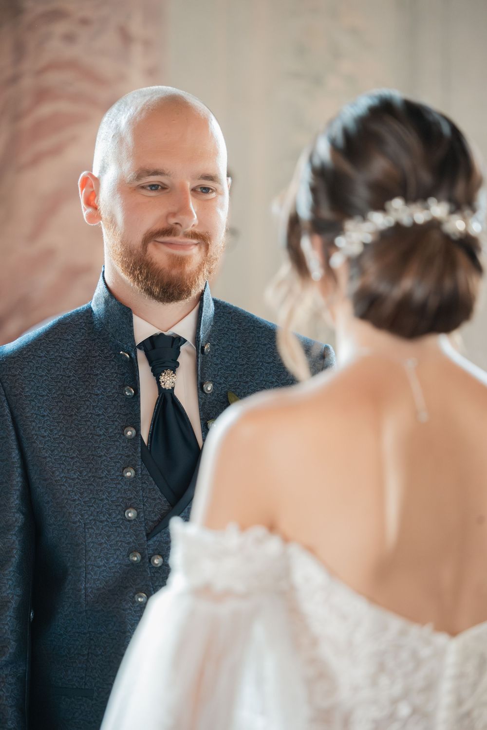 Emotional first look moment between couple at elegant indoor wedding venue.