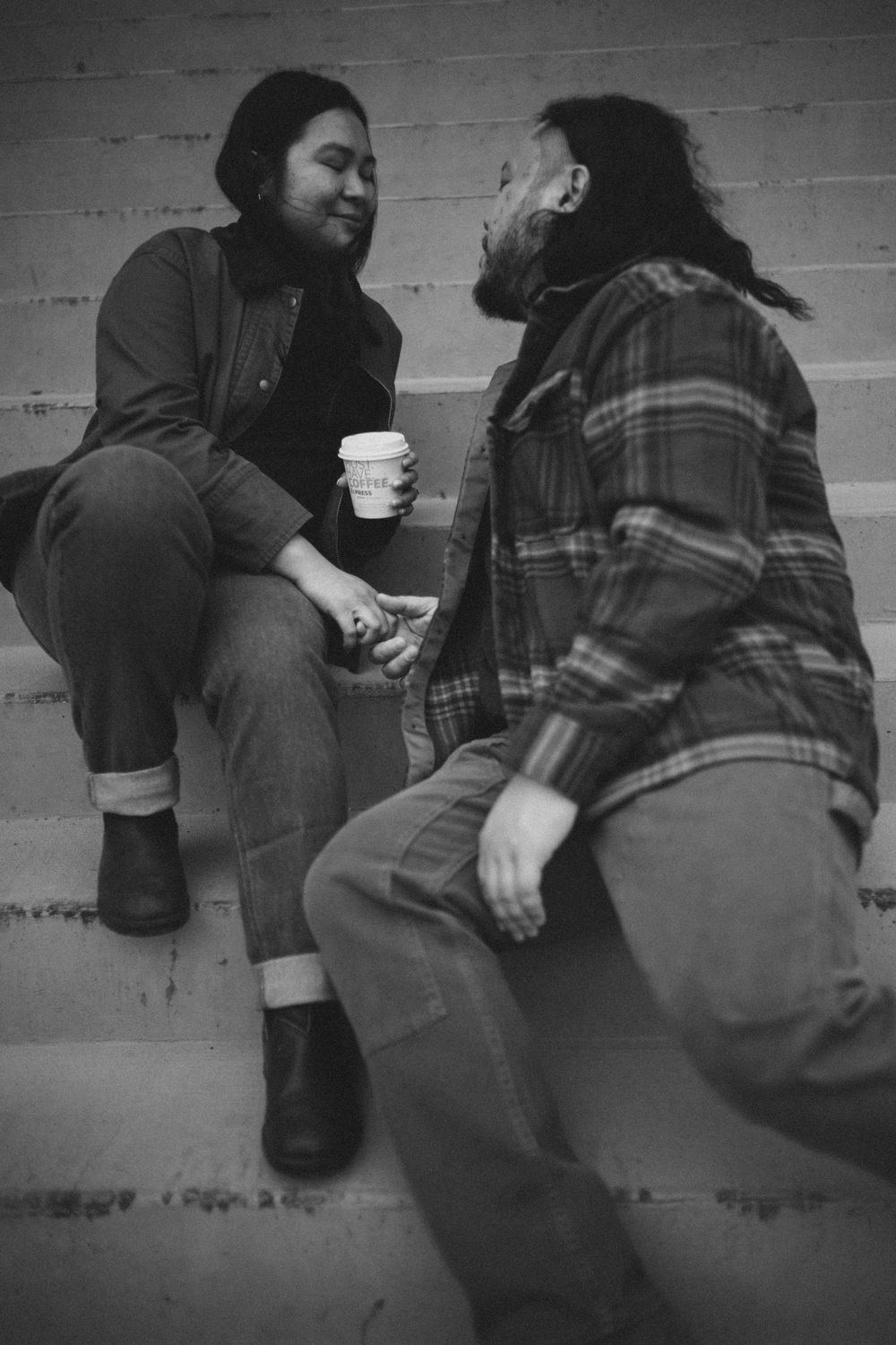 A black and white photo sequence shows two people sitting and interacting on steps in a casual setting.