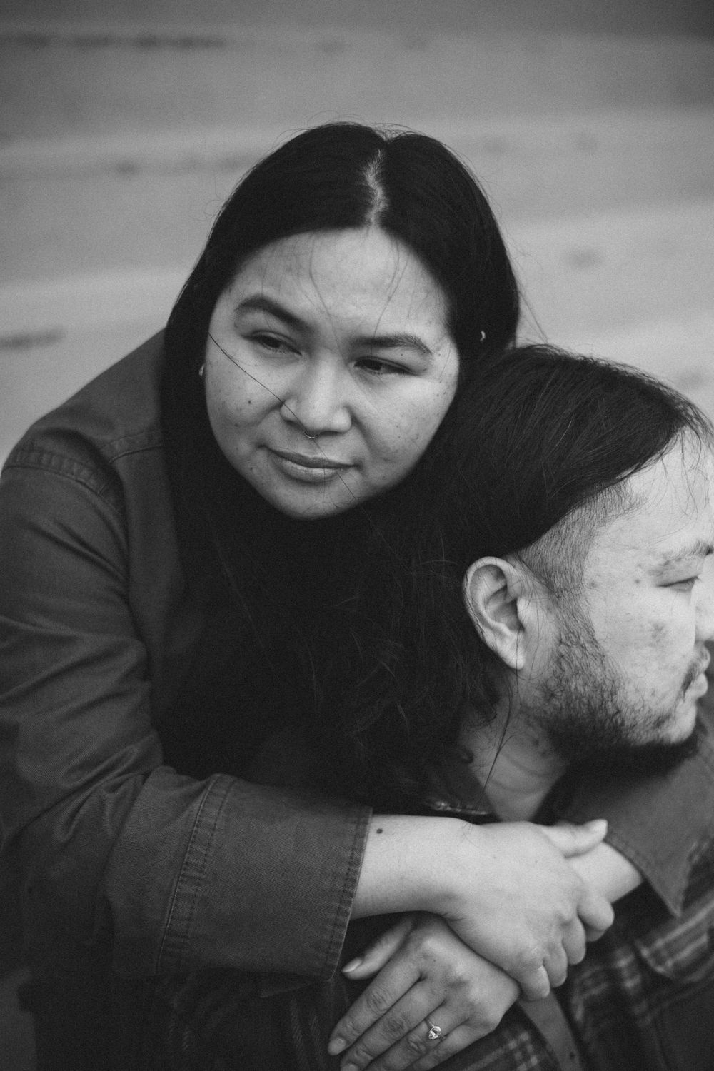 A tender black and white portrait of a couple embracing in an intimate moment.