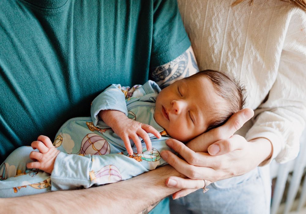 A series of tender moments showing a parent's hands gently holding and comforting a newborn baby.
