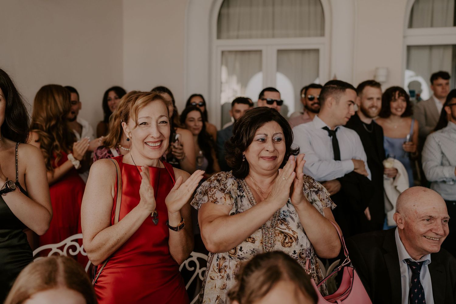Wedding celebration with guests dancing and enjoying themselves in an elegant venue.