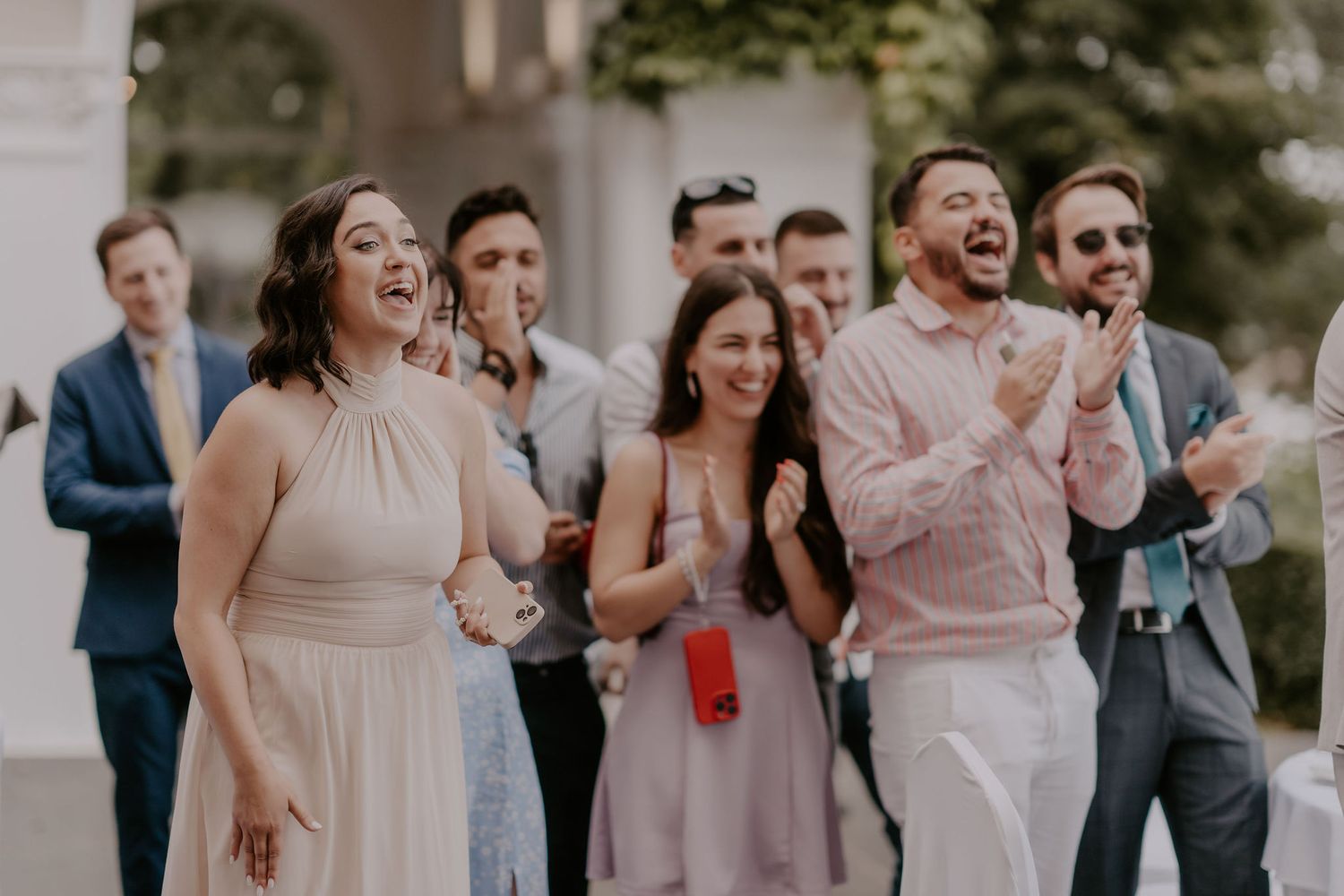 Wedding guests enjoy a lively celebration on an outdoor patio.