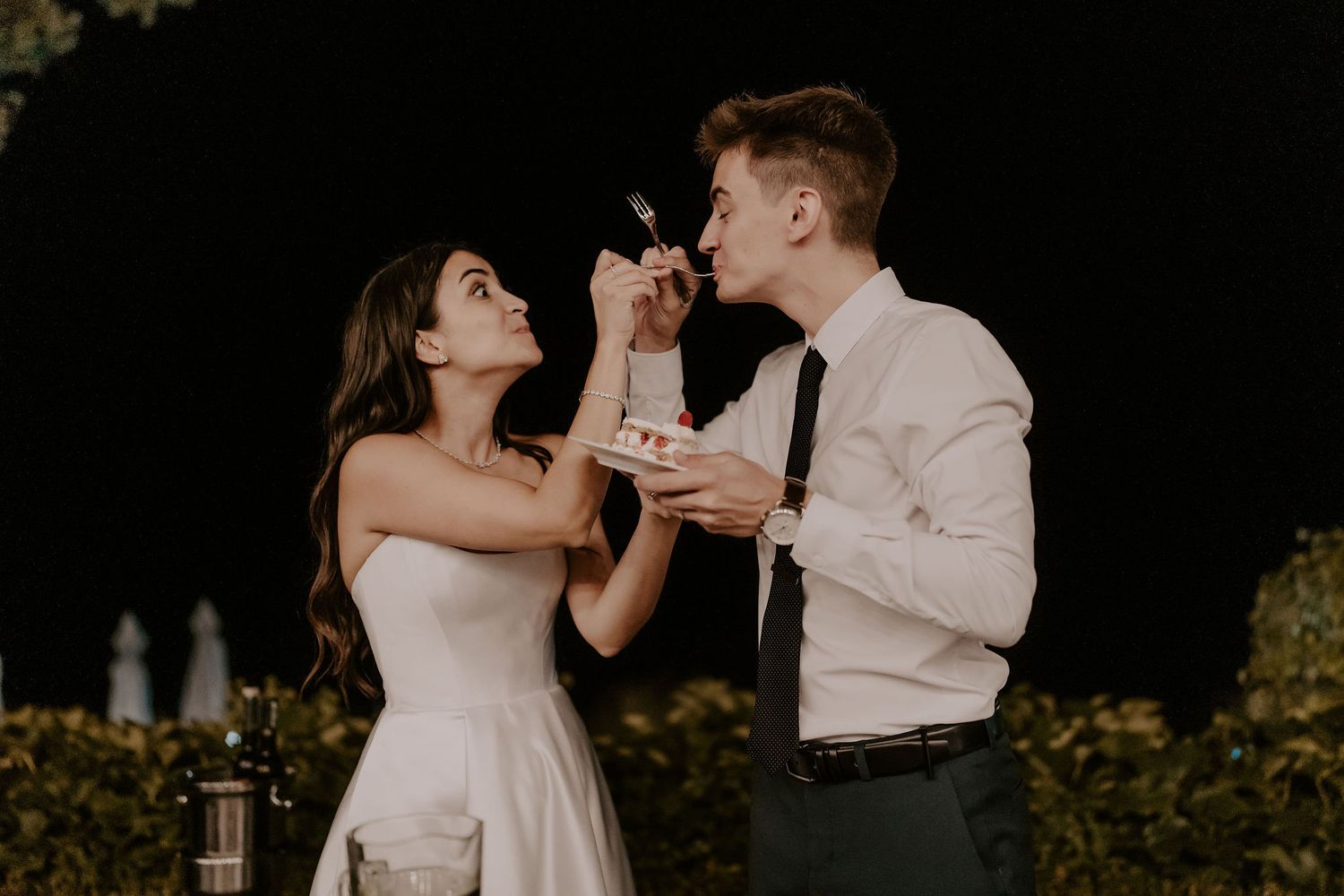 Newlyweds share an intimate moment during their cake cutting ceremony.