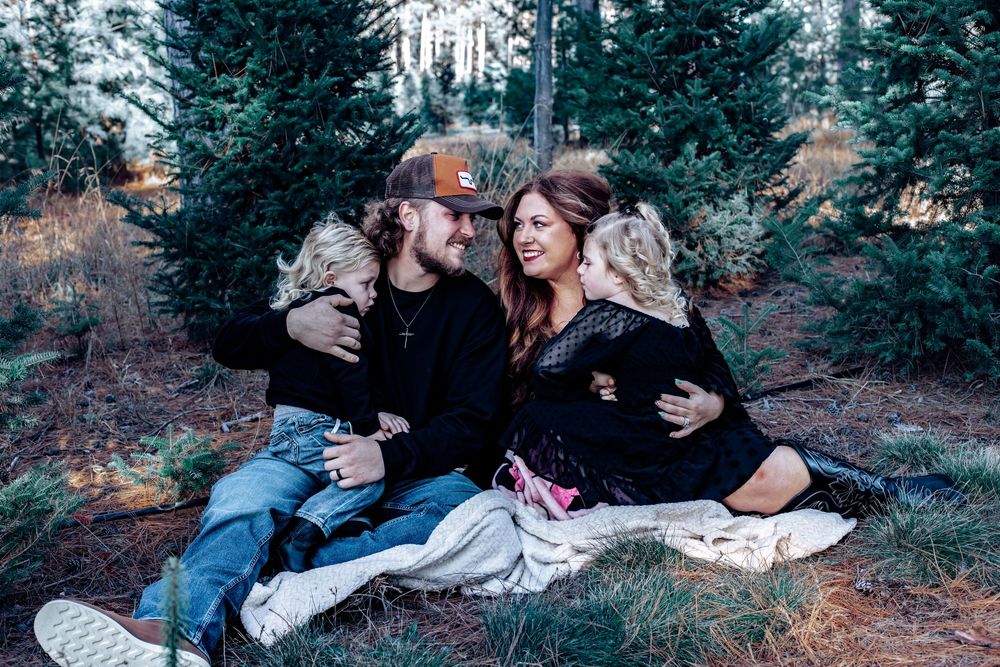Romantic couples photoshoot in a snowy forest setting with dramatic poses.