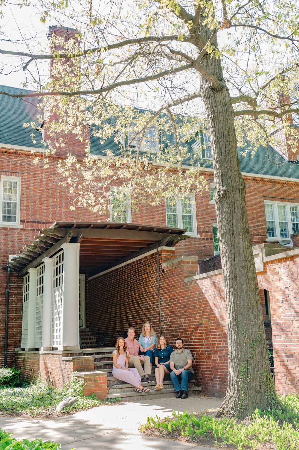 family next to building at Aquinas college