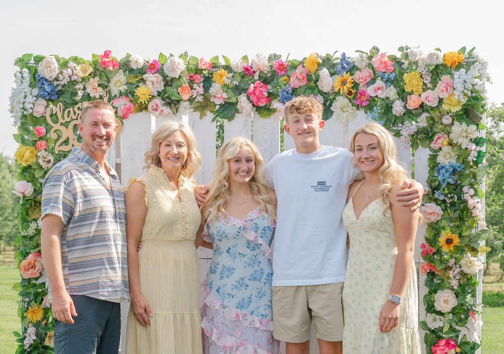 family in front of grad flowers