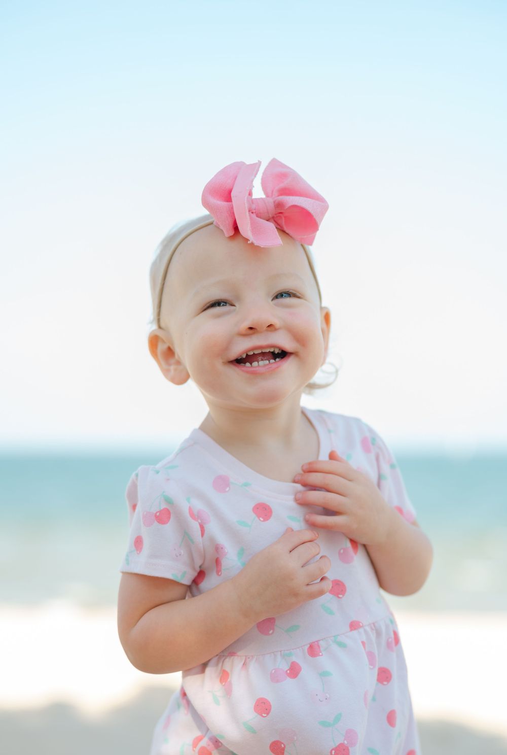 little girl with a bow smiling