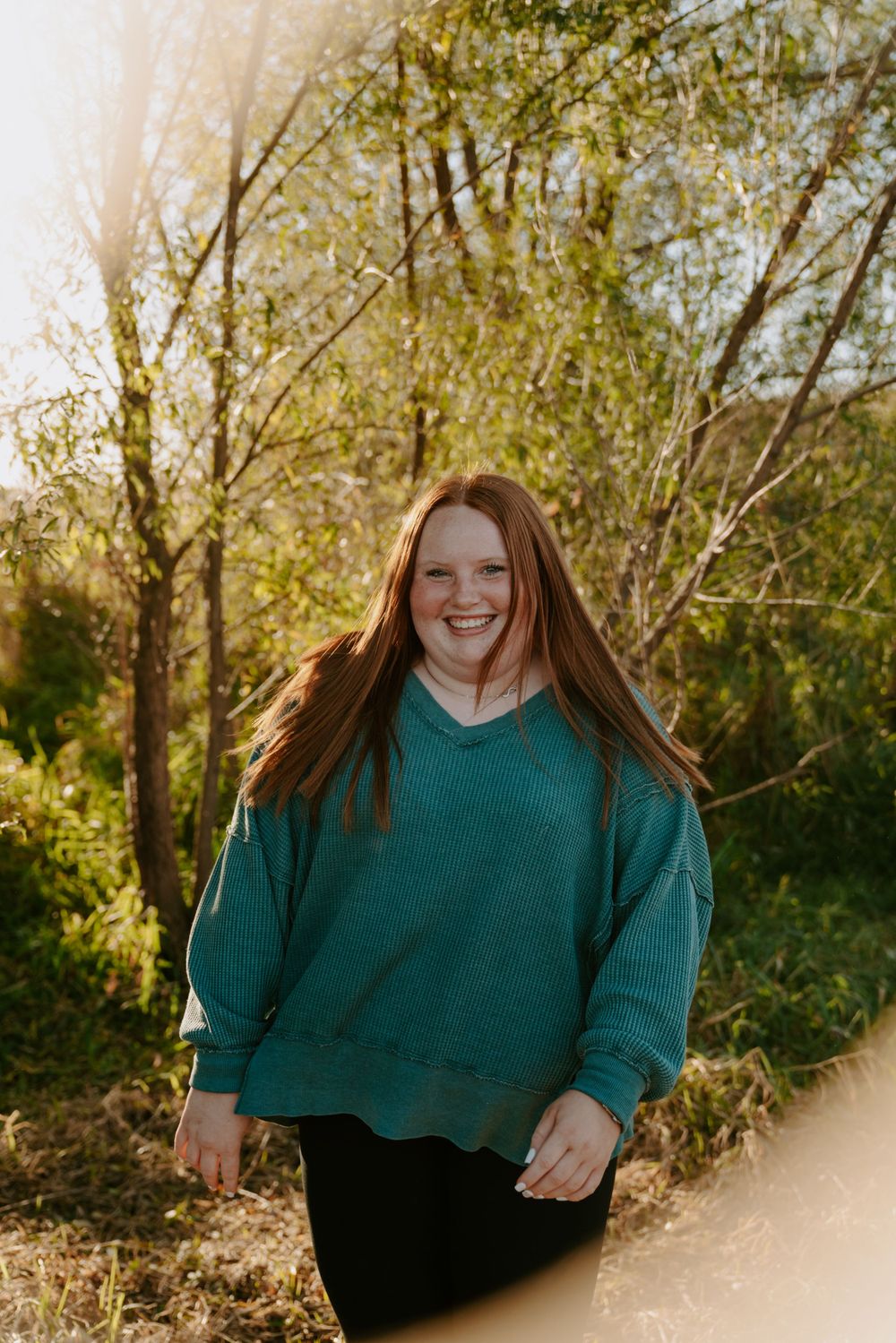 Natural candid portraits in golden hour light wearing dark teal knit sweater.
