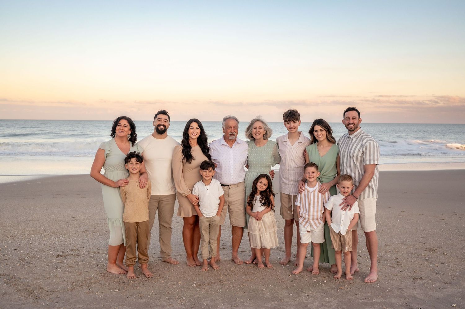 Beach photoshoot extended family with small kids and grandparents at sunset with gorgeous colors Palm Bay Cocoa Beach Vero Florida Brevard