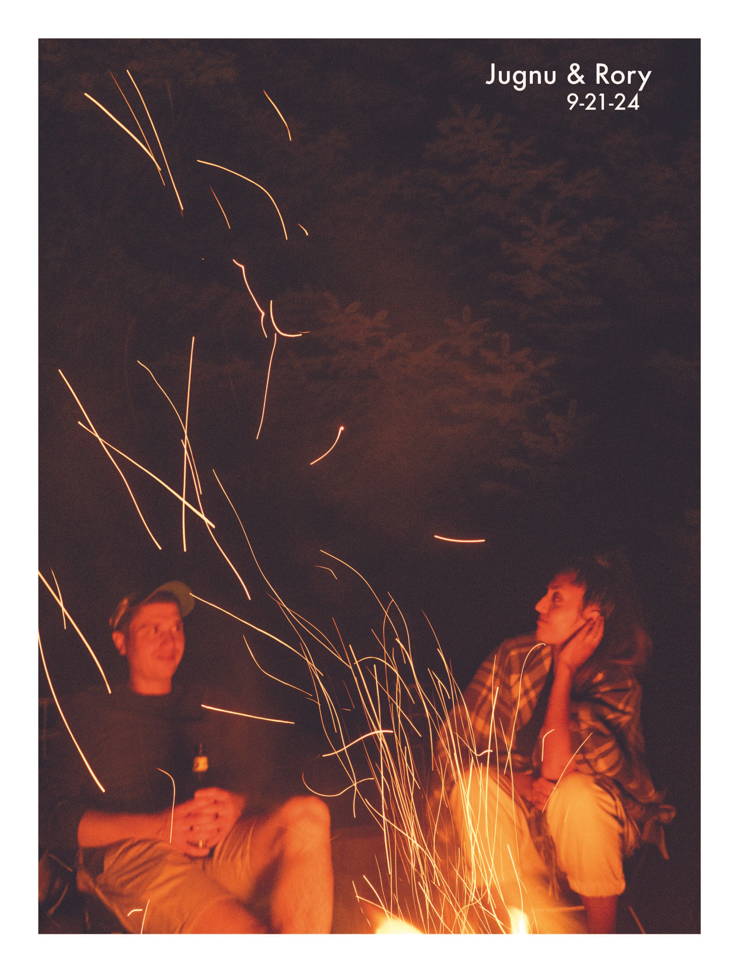 Two people sitting by a campfire with sparks flying, dated Jugnu and Rory 9-21-24.