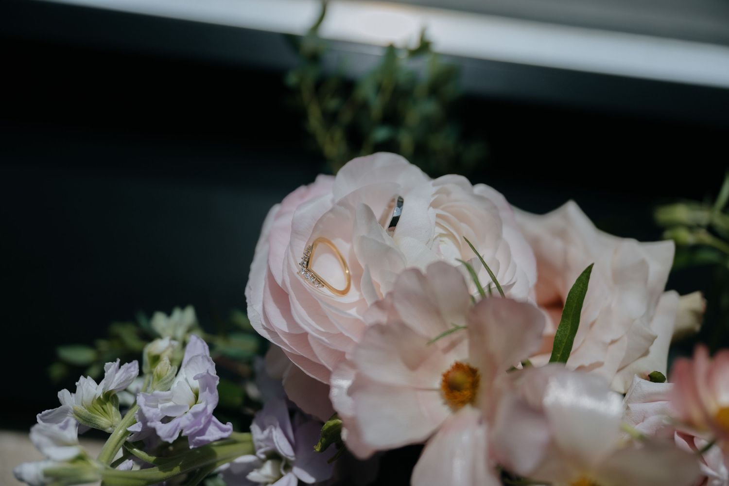 Soft pink garden roses and delicate white flowers in a romantic bridal wedding bouquet arrangement.