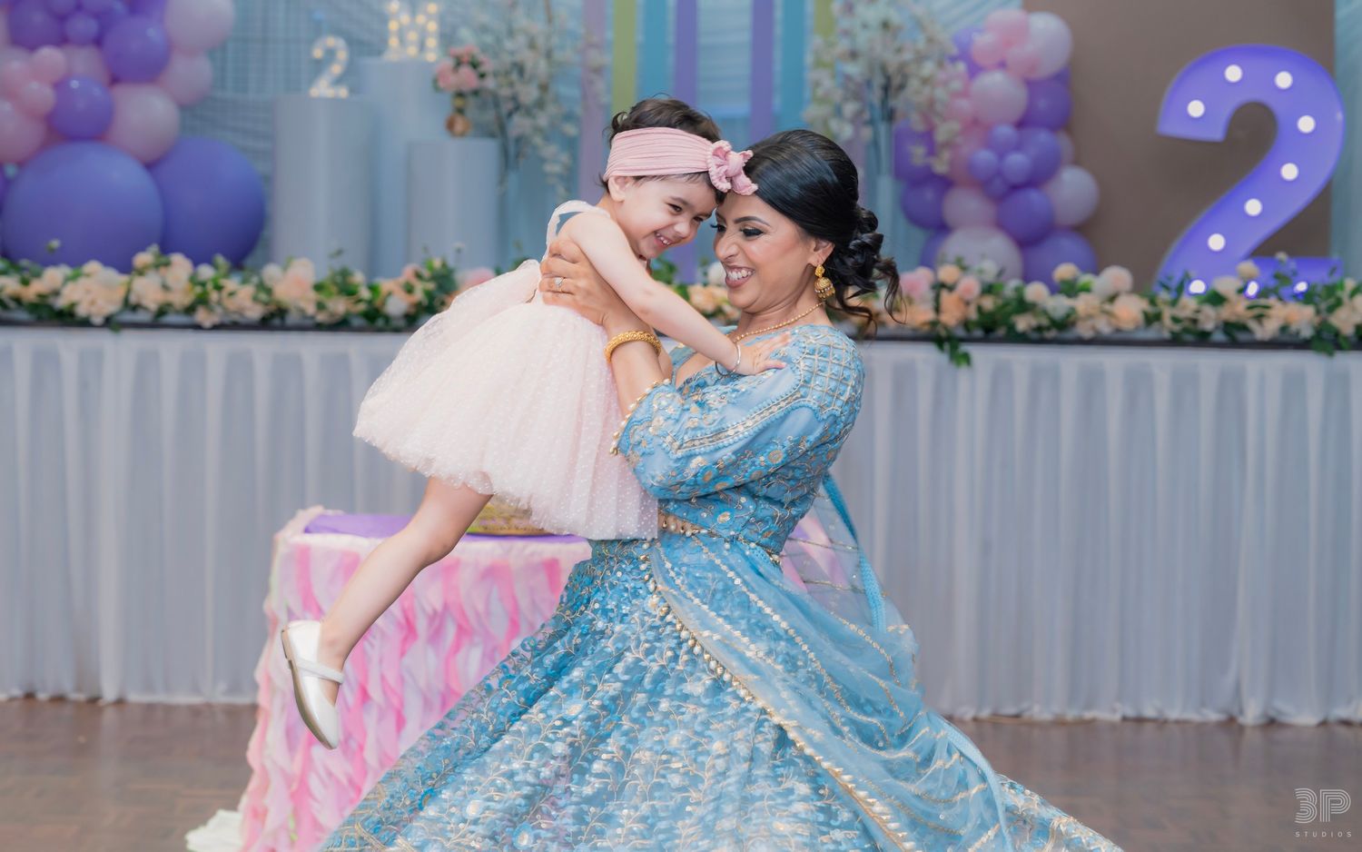 A celebratory moment in blue and pink decor featuring a beautiful princess-themed party scene.