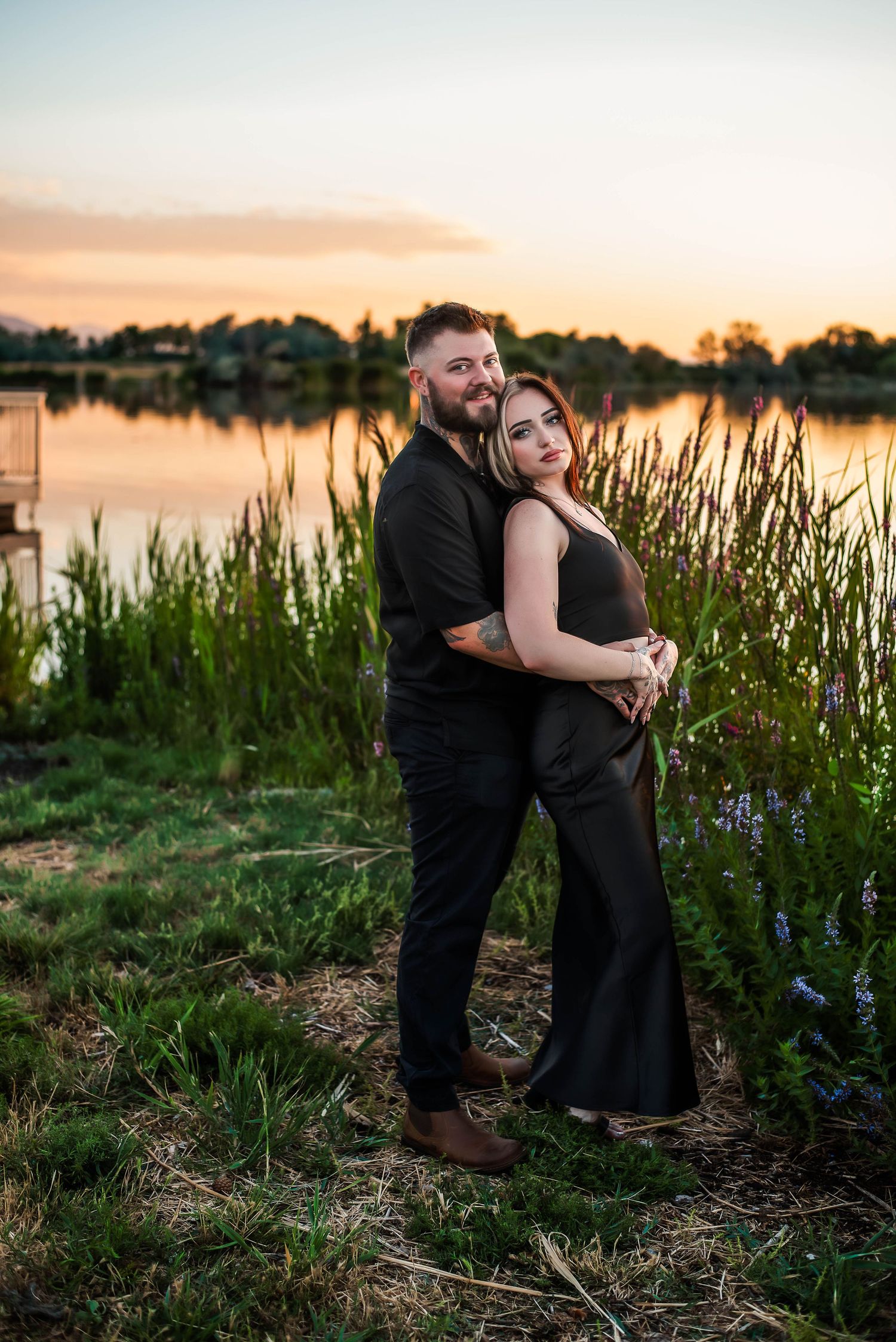 Couple embracing in front of the lake during sunset at Bountiful, Utah