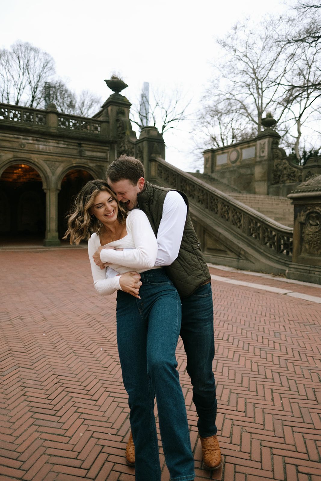 Couple embracing and laughing at Bethesda Terrace in Central Park, New York City.