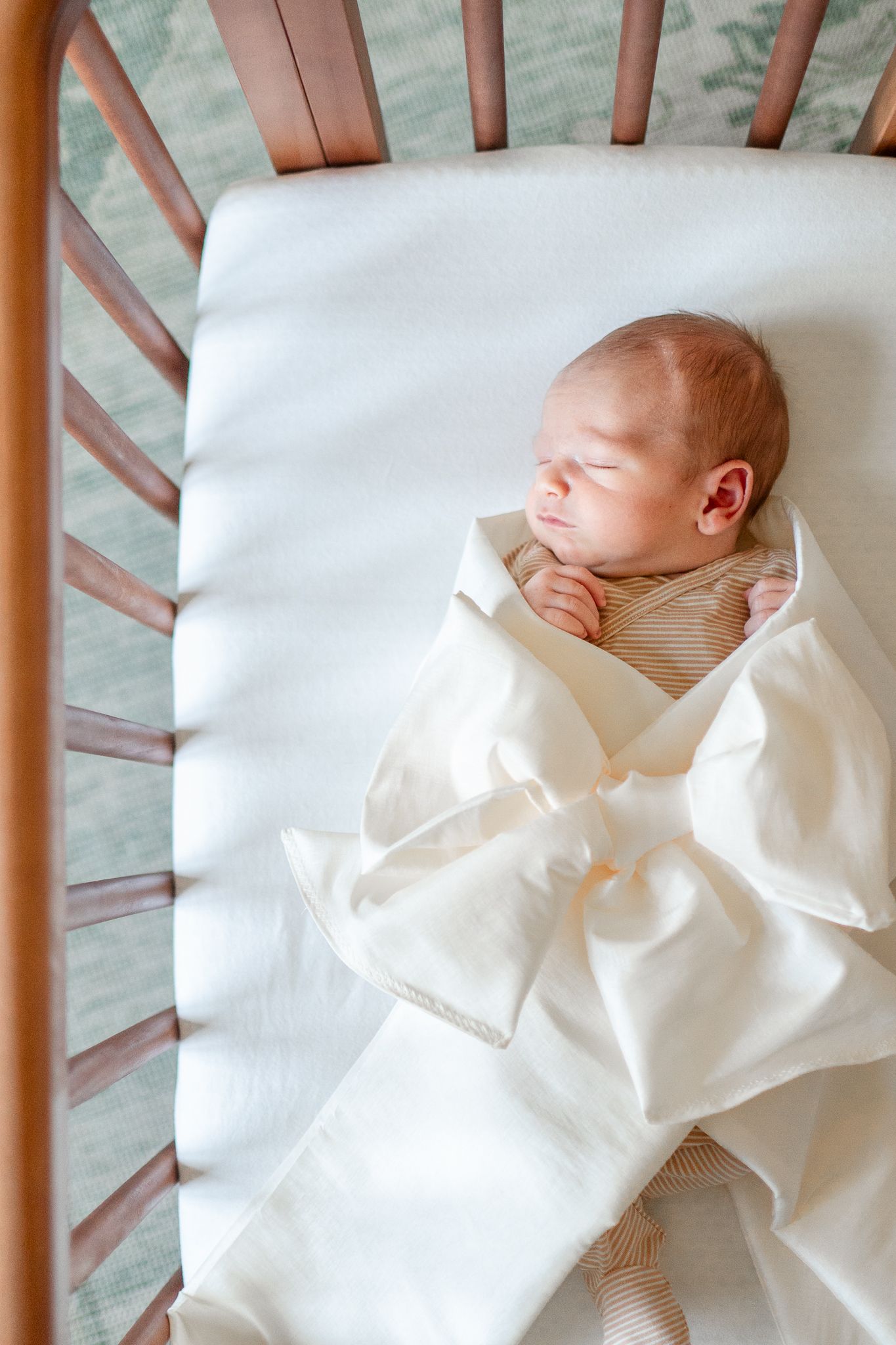 Baby sleeps in a special family-made wrap at his newborn session.