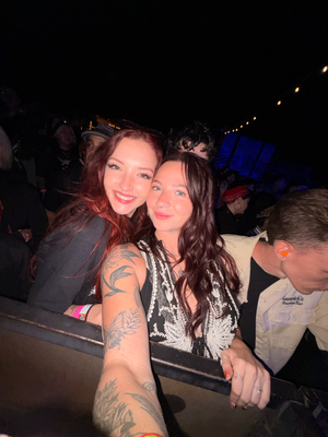 Two people enjoying a night out at what appears to be a dimly lit bar or club setting.