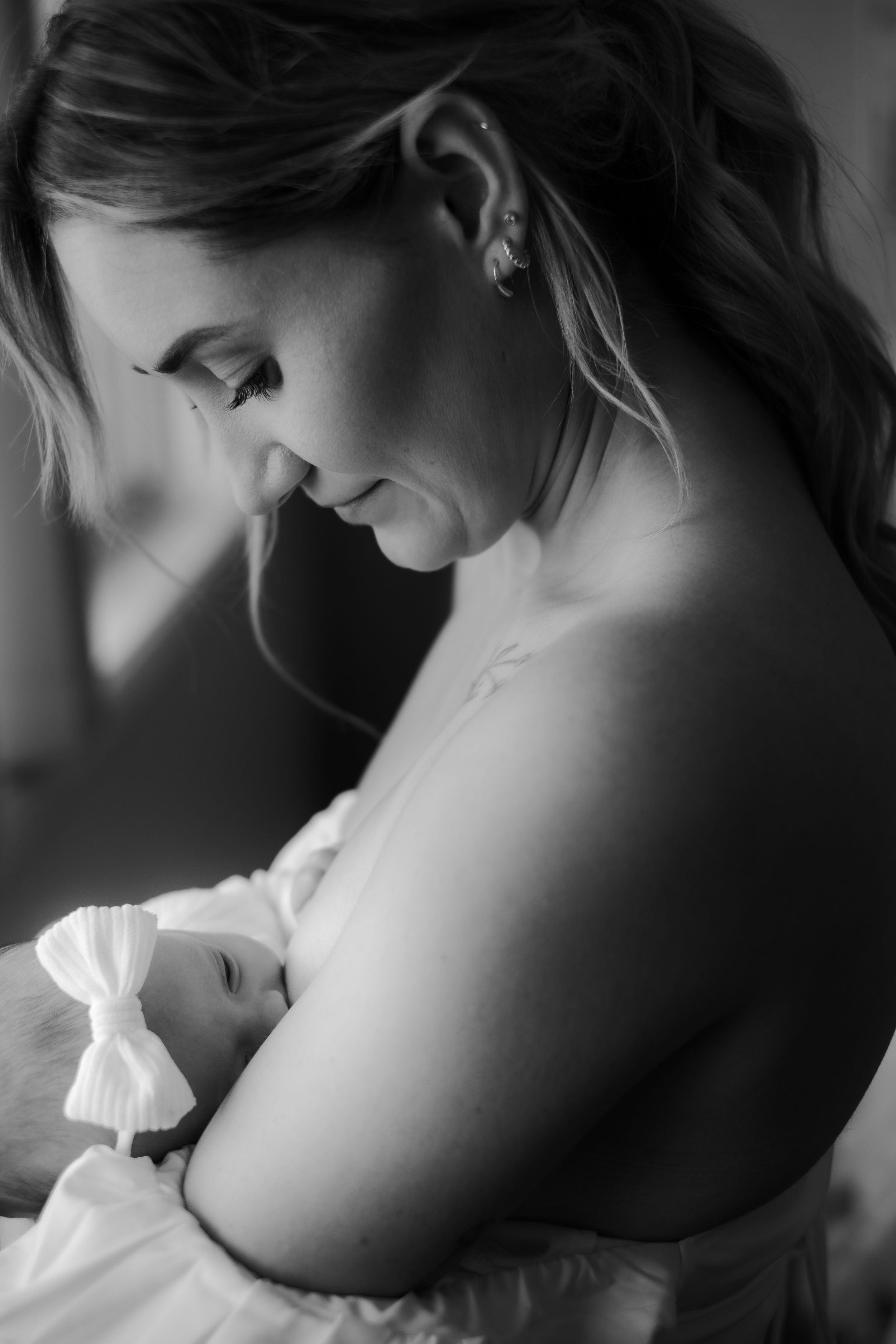 Intimate black and white portrait showing tender motherhood moment.