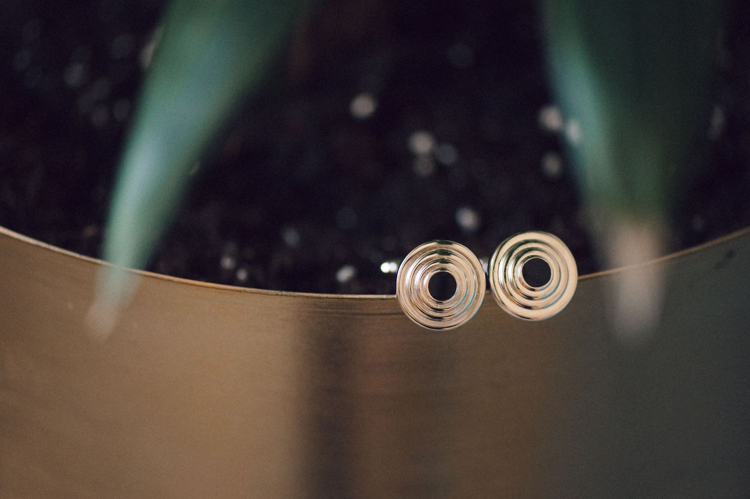 A close-up view of metal springs on a dark background showing their coiled spiral pattern.