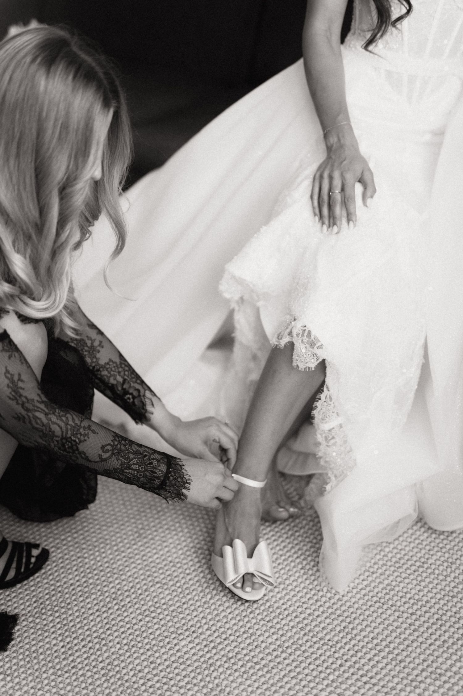 Black and white series of photos showing bride's feet in elegant white shoes and lace dress details.