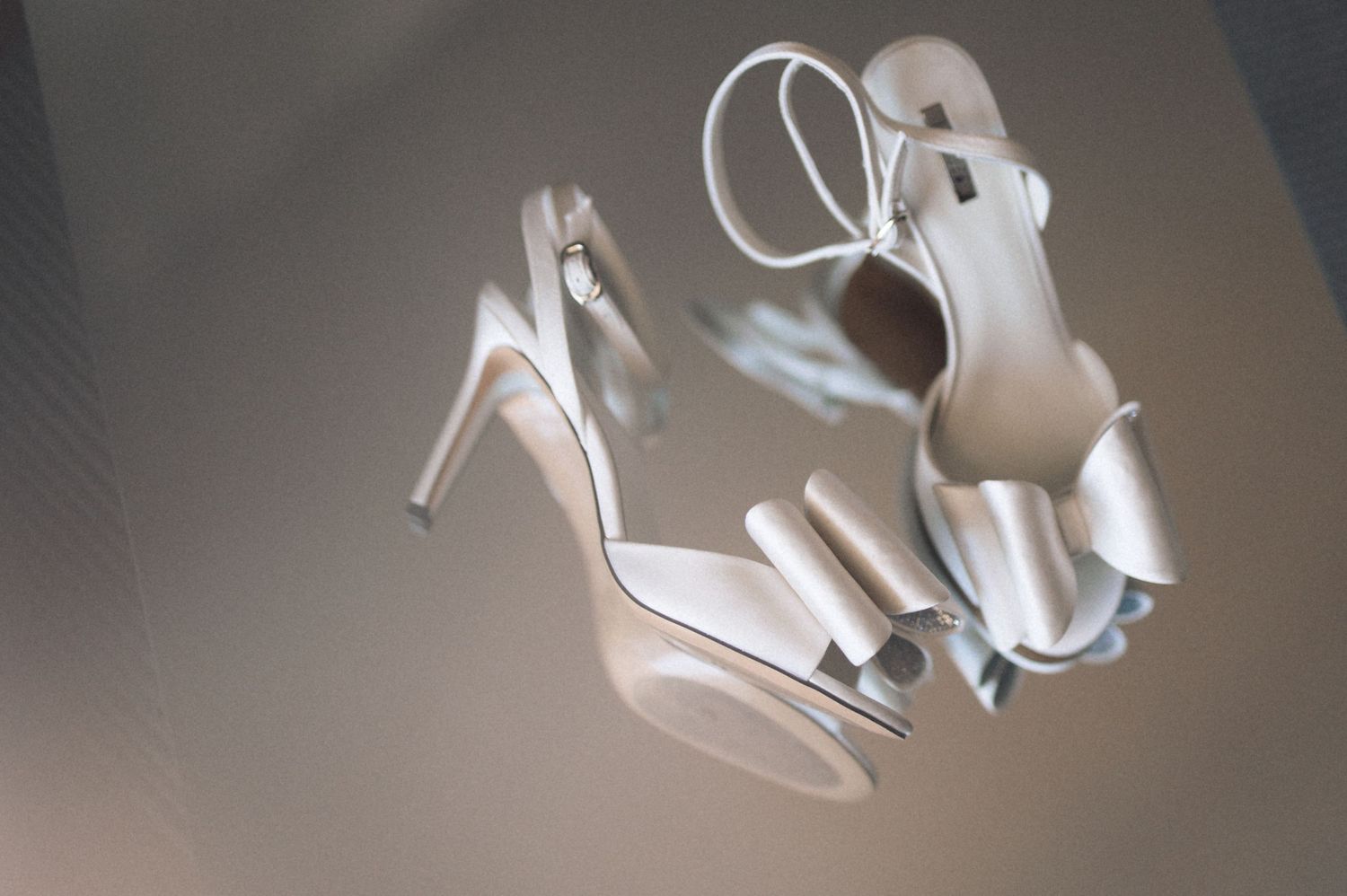 A collection of white high heel shoes arranged in a row showing different angles and perspectives.