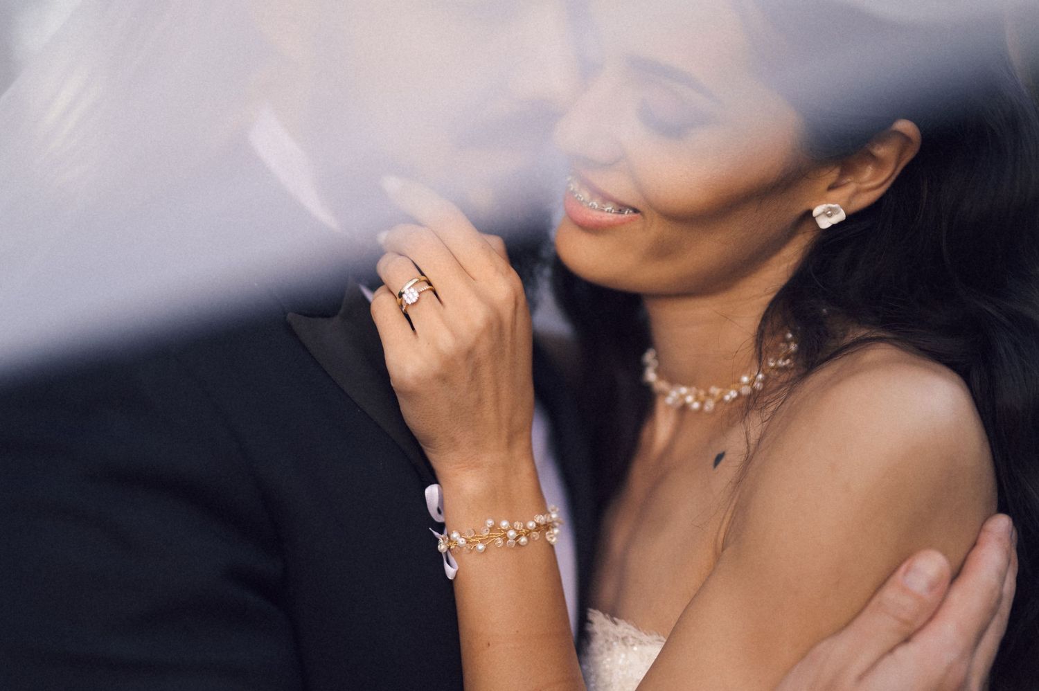 Woman wearing elegant jewelry and makeup poses in multiple glamorous shots against dark background.