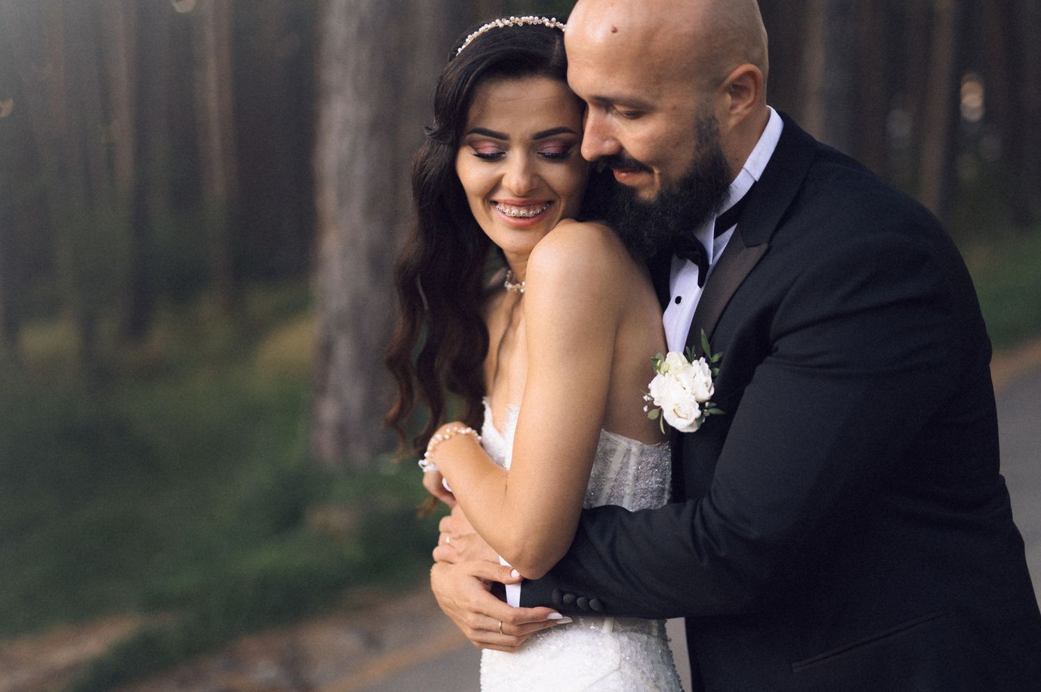 Bride and groom share intimate moments in romantic wedding photos against a natural outdoor backdrop.