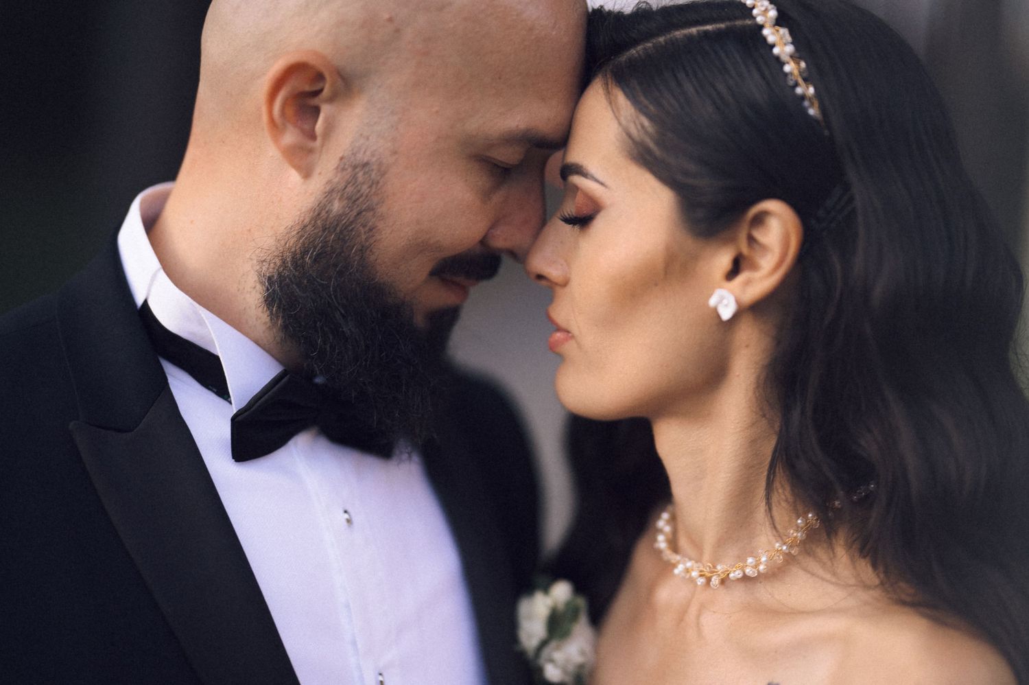 Romantic wedding photo series showing tender moments between newlyweds in formal attire.