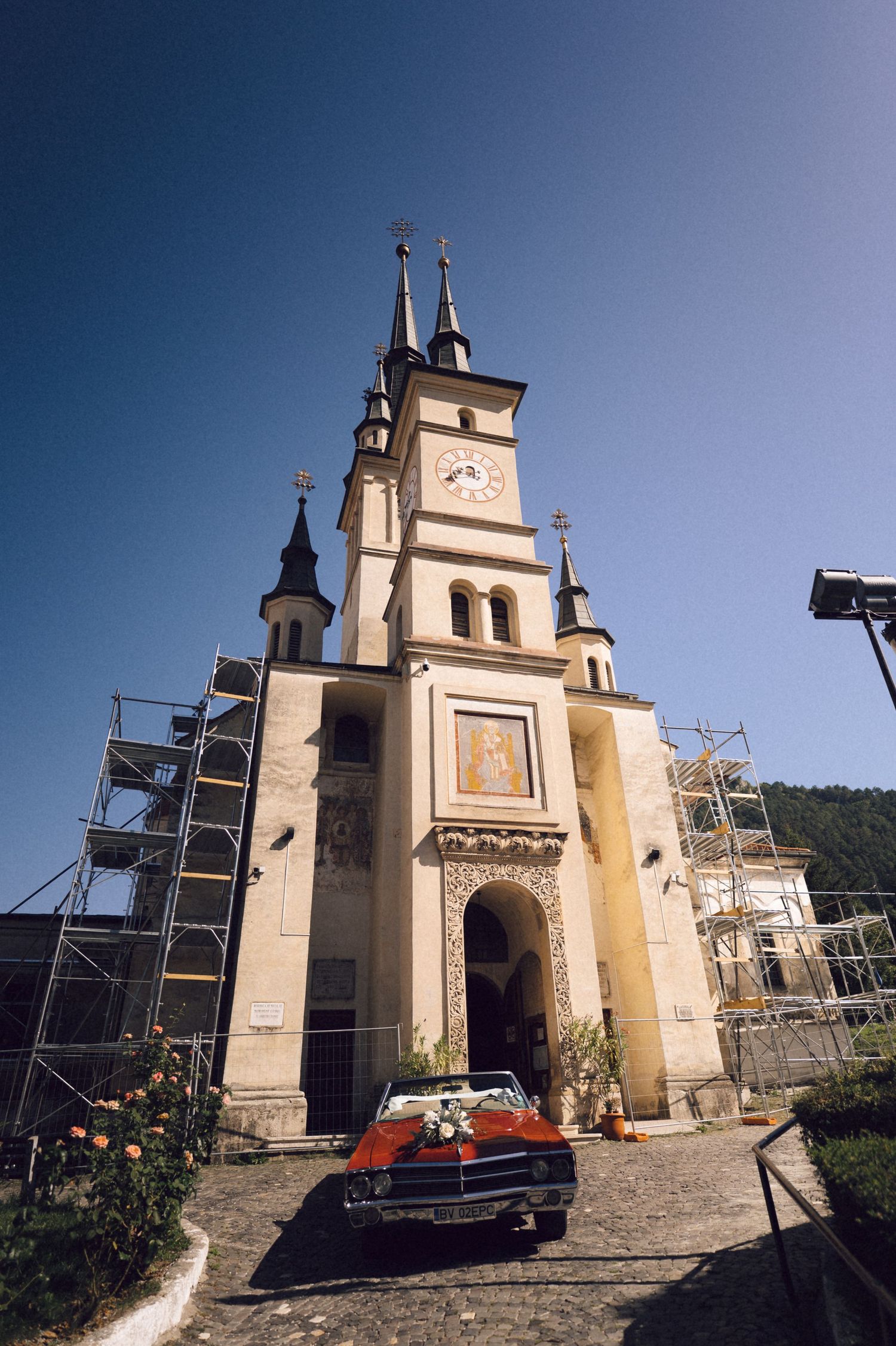 Historic church facade with scaffolding undergoing restoration work shown from different angles against a blue sky.