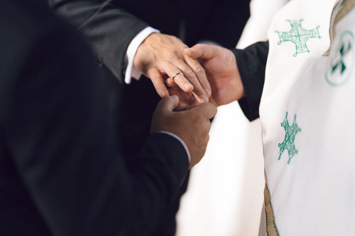 Business professionals shake hands while holding documents with green star symbols in an office setting.