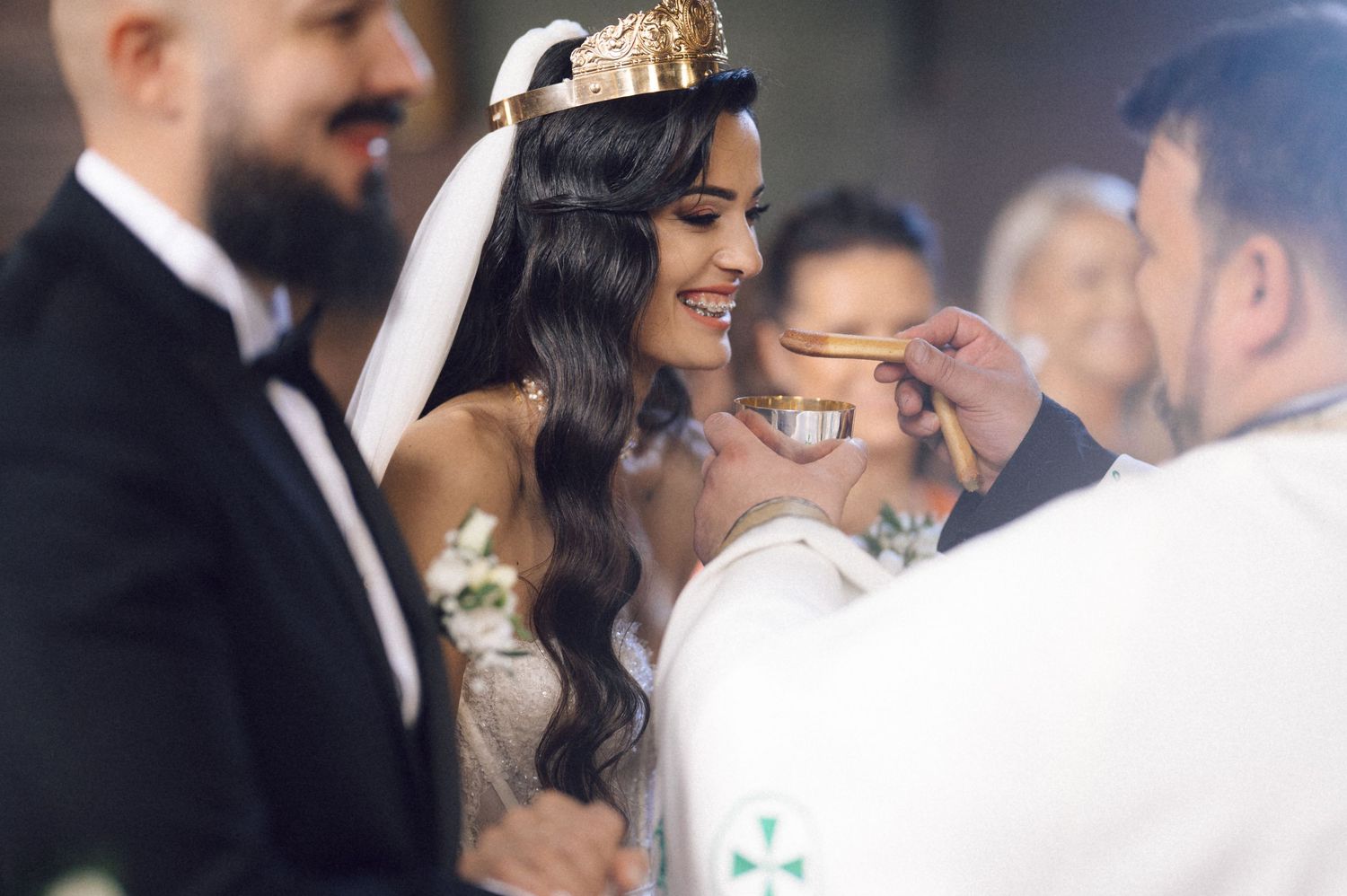 Wedding guests share joyful moments and laughter during an elegant reception celebration.