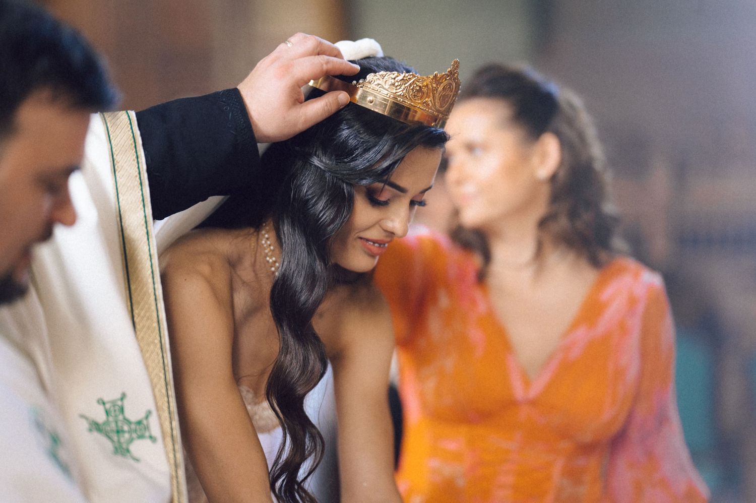 Two people in traditional Indian wedding attire embrace in a romantic moment during their celebration.