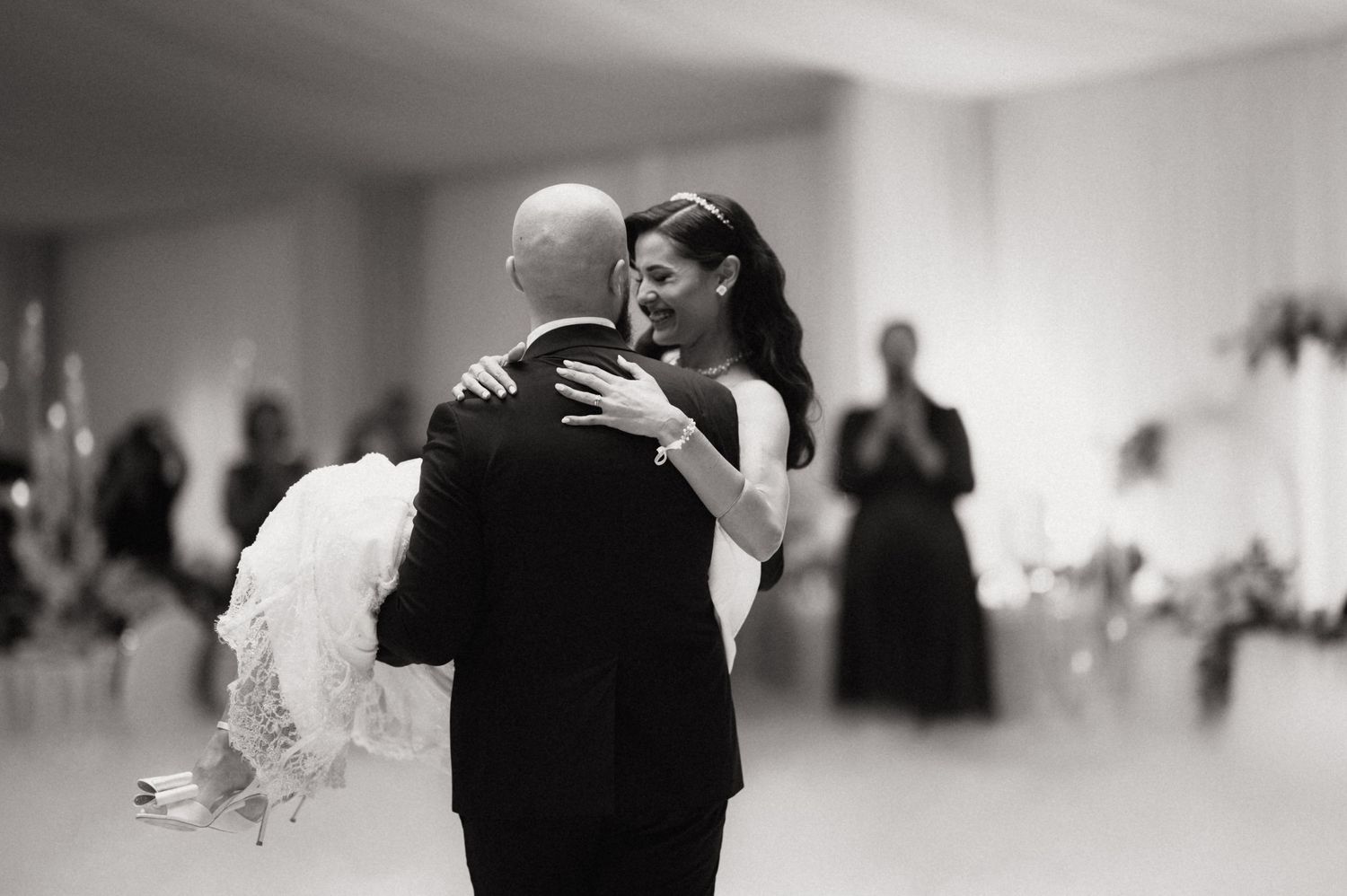 A black and white collage of wedding dance moments showing couples embracing on the dance floor at a reception.