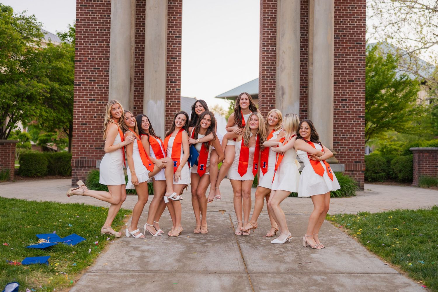 A large group of girl UIUC students doing a crazy, fun pose in front of Hallene Gateway