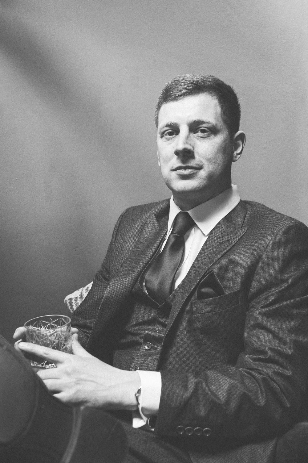 A series of vintage black and white portrait photographs showing formal poses in suits.