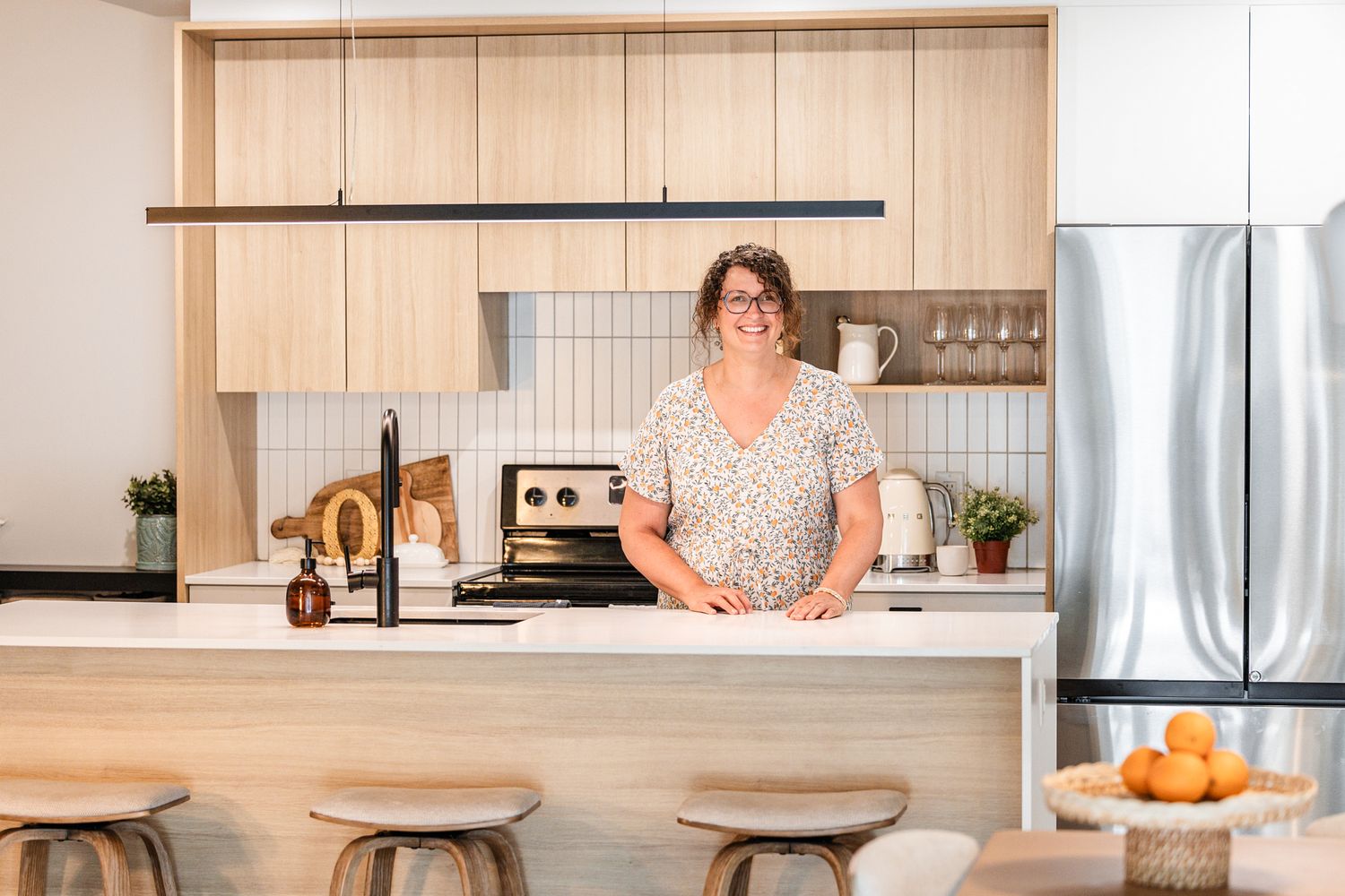 Modern kitchen interior with wood cabinets and minimalist design.