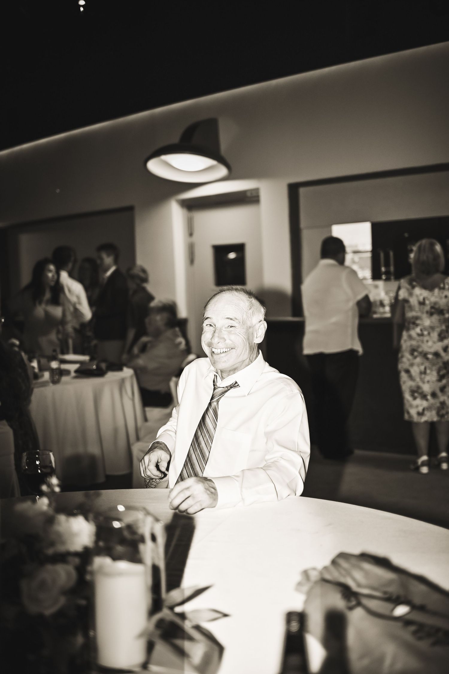 Man smiling and posing at a wedding reception, black and white, Newfoundland.