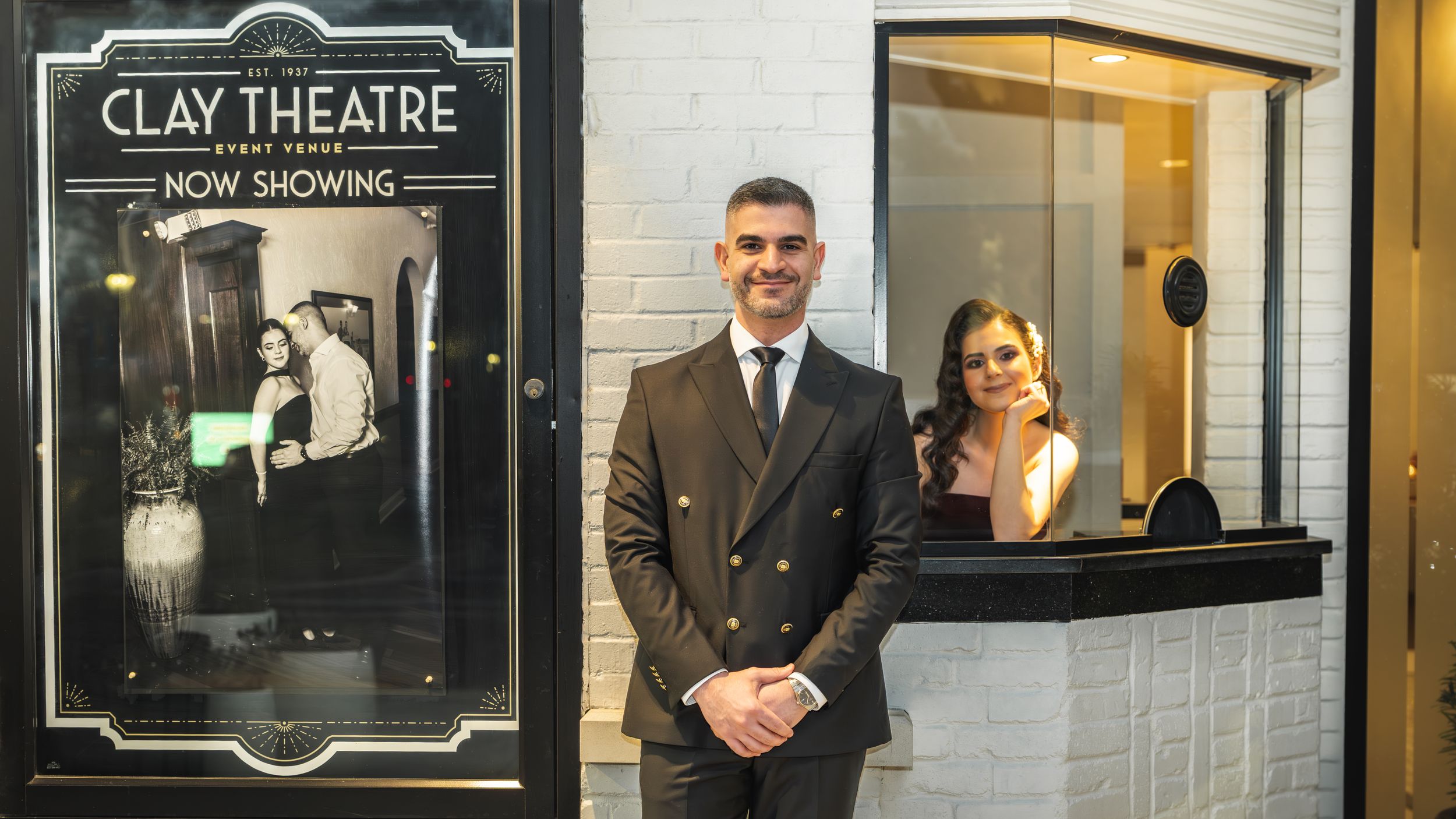 A classic art deco movie theater entrance with Clay Theatre signage and illuminated display cases.