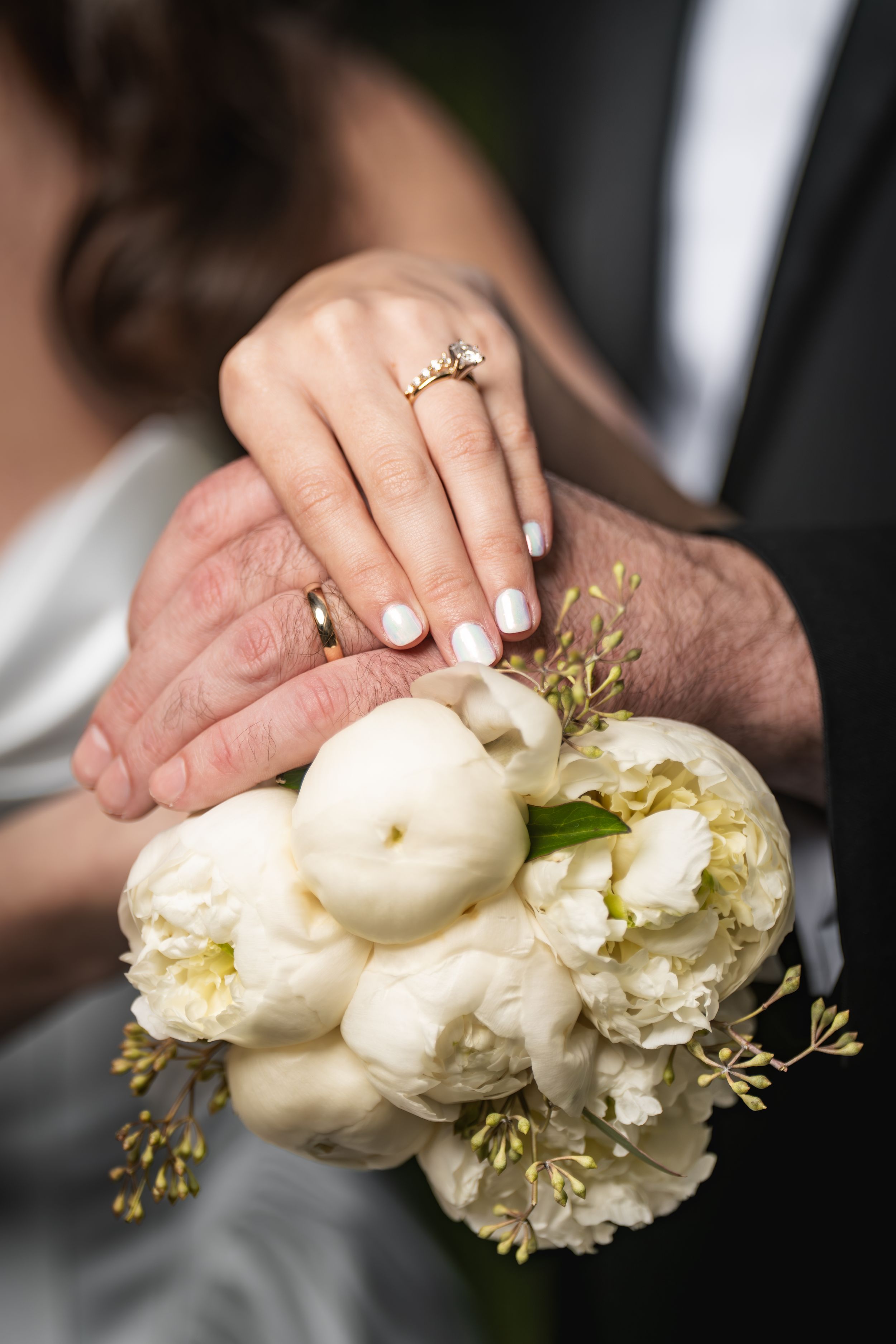 A series of elegant white floral bouquets with delicate petals and greenery shown in close-up detail.